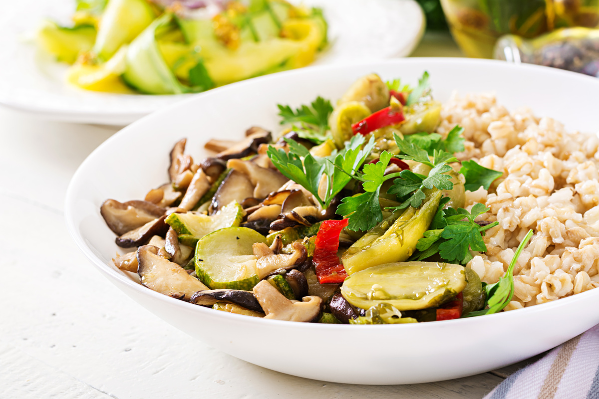 Diet menu. Healthy vegetarian meal - mushrooms shiitake, zucchini  and oatmeal porridge on bowl. Vegan food.